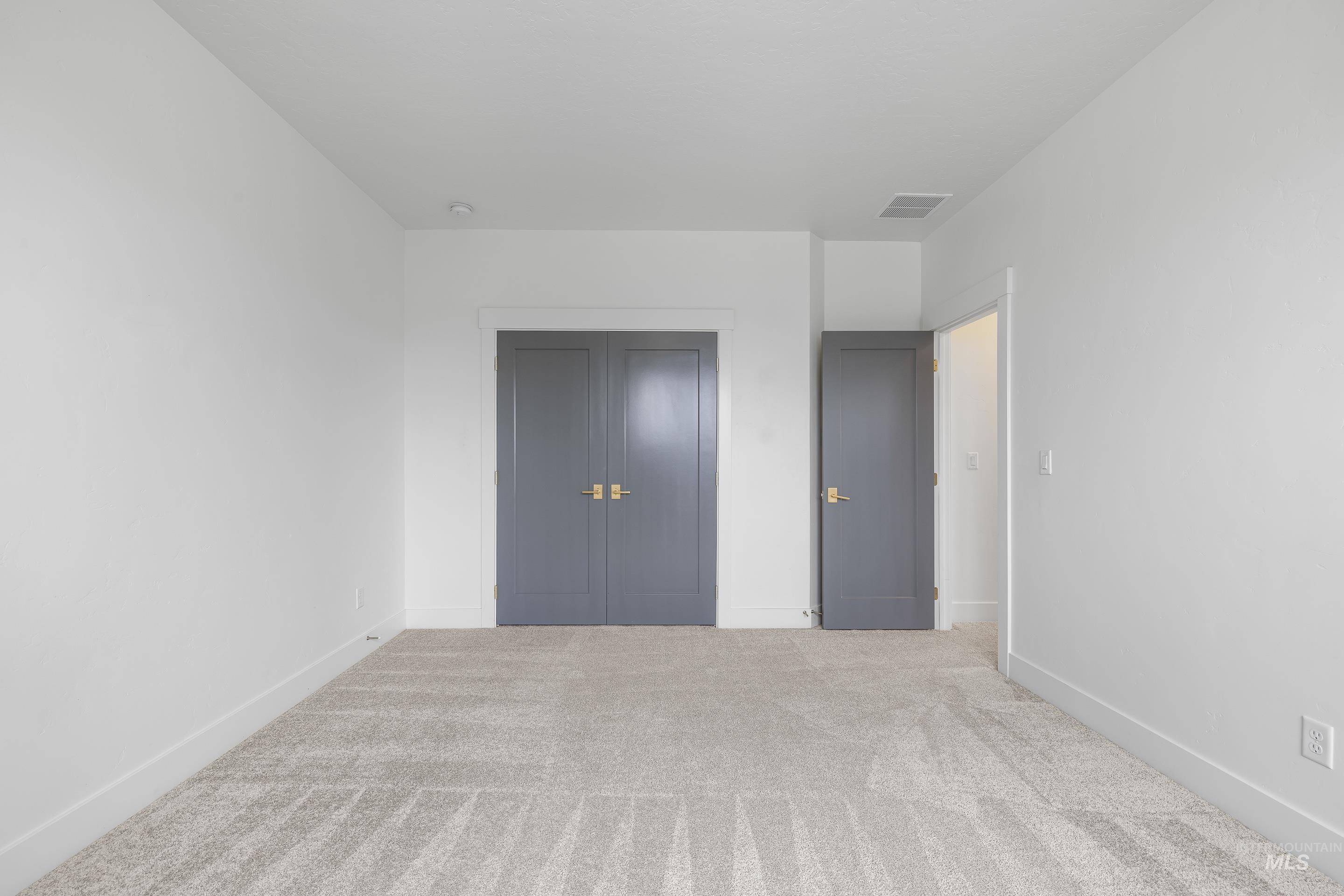747 South Short Road Eagle, ID 83616 - Photo 36 of 48 Unfurnished bedroom featuring light carpet and a closet