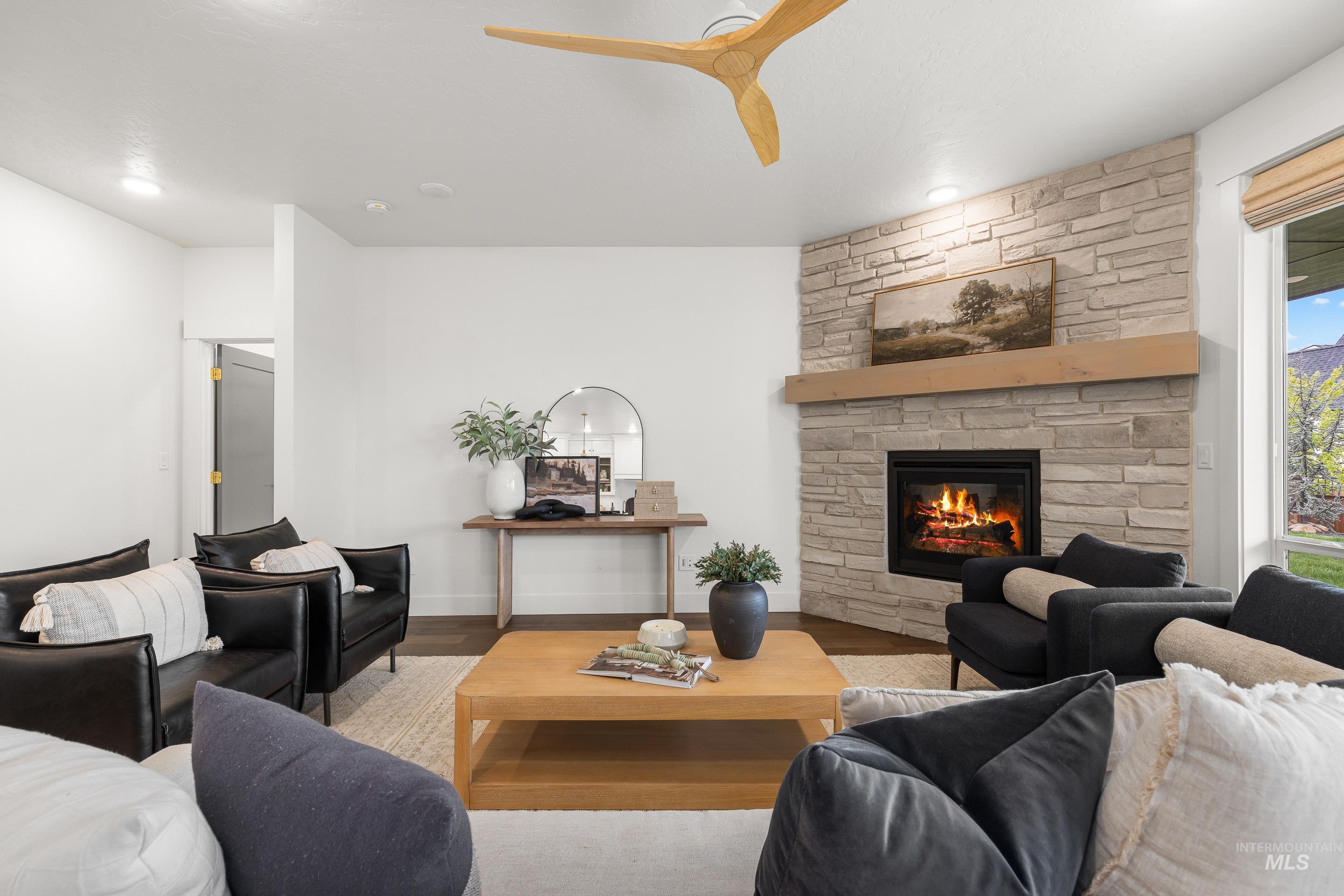 747 South Short Road Eagle, ID 83616 - Photo 7 of 48 Living area with a ceiling fan, a fireplace, and wood finished floors