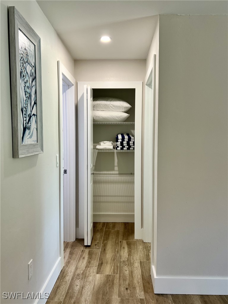 5117 Sea Bell Road, Unit F104 Sanibel, FL 33957 - Photo 12 of 41 a view of a hallway with wooden floor and closet