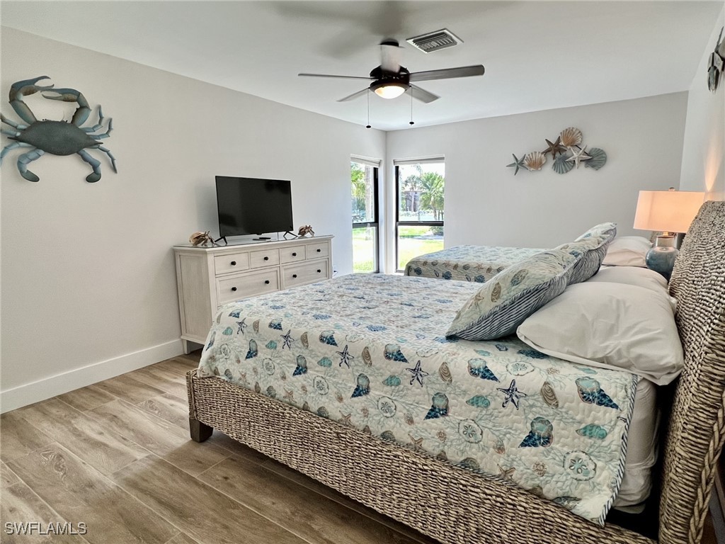 5117 Sea Bell Road, Unit F104 Sanibel, FL 33957 - Photo 24 of 41 a bedroom with a bed and flat screen tv