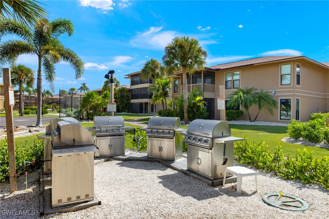 5117 Sea Bell Road, Unit F104 Sanibel, FL 33957 - Photo 30 of 41 a view of a patio with table and chairs potted plants