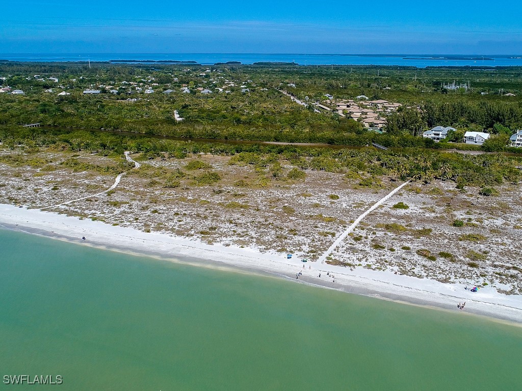 5117 Sea Bell Road, Unit F104 Sanibel, FL 33957 - Photo 39 of 41 a view of a yard with an ocean