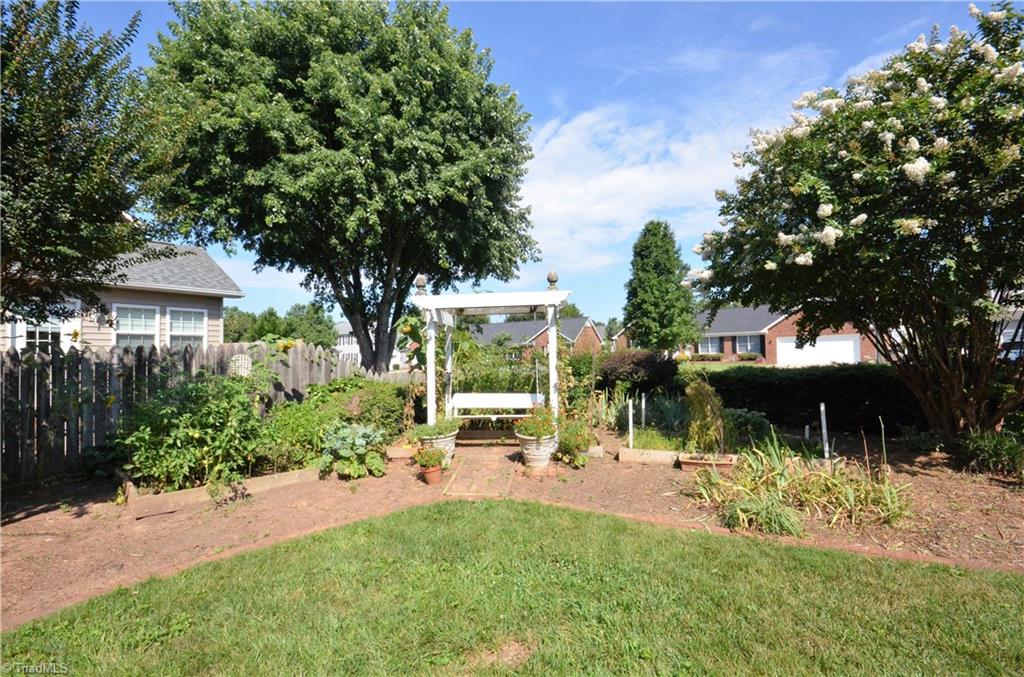 3925 Braddock Road High Point, NC 27265 - Photo 4 of 28 beautiful back yard with a garden, swing and pergola.