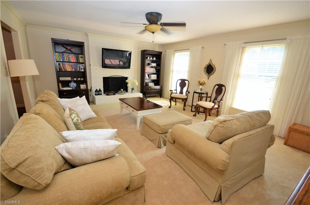 3925 Braddock Road High Point, NC 27265 - Photo 7 of 28 Living room with a wood burning fire place and plenty of natural light.