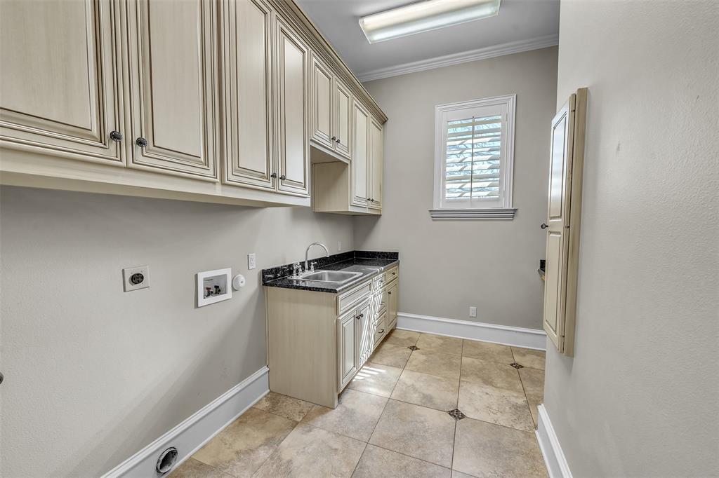 2909 Canyon Creek Drive Sherman, TX 75092 - Photo 22 of 40 a kitchen with granite countertop white cabinets and white appliances