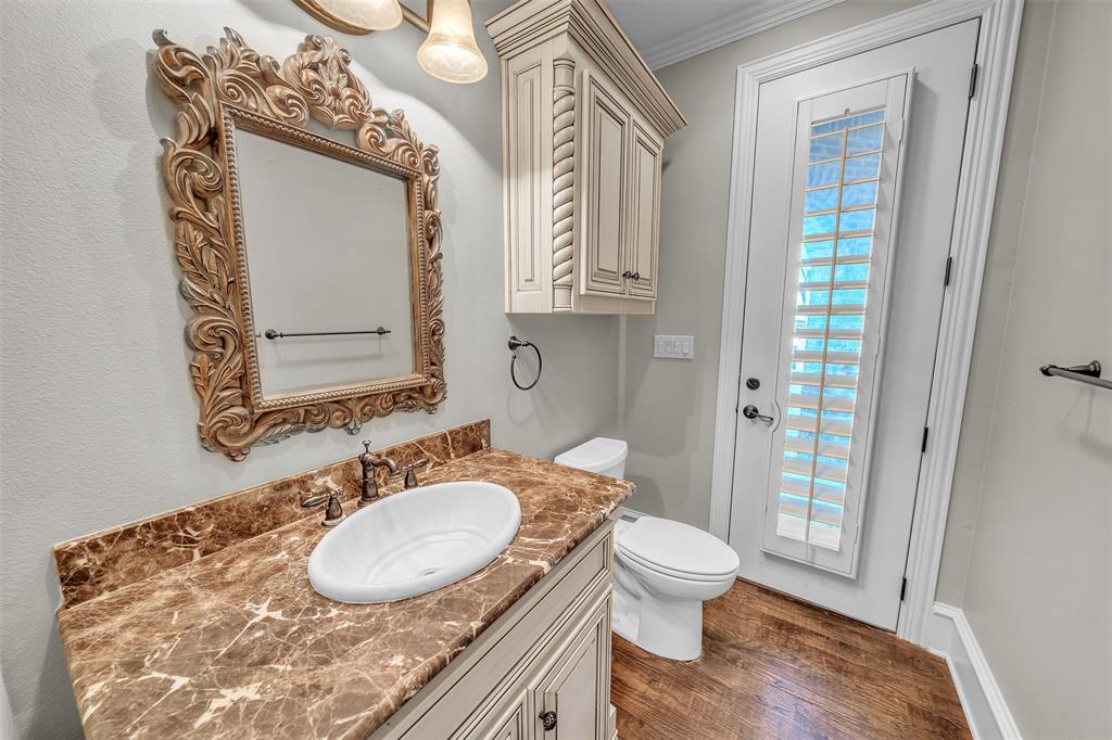 2909 Canyon Creek Drive Sherman, TX 75092 - Photo 23 of 40 a bathroom with a granite countertop sink toilet a mirror and shower