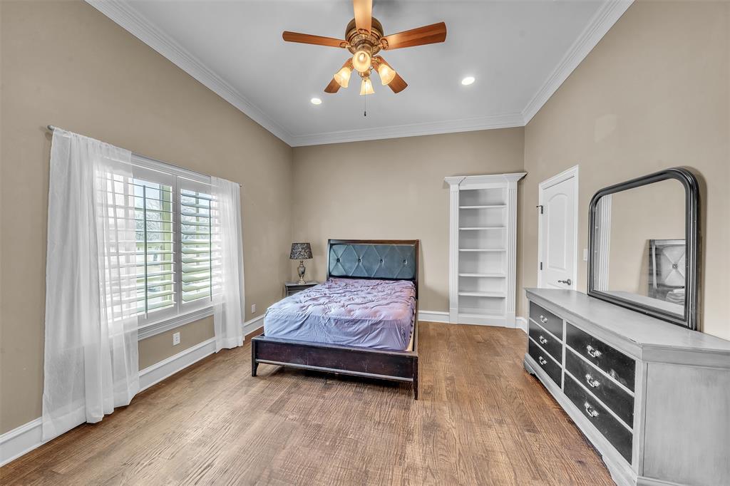 2909 Canyon Creek Drive Sherman, TX 75092 - Photo 26 of 40 a bedroom with a bed and a dresser with wooden floor