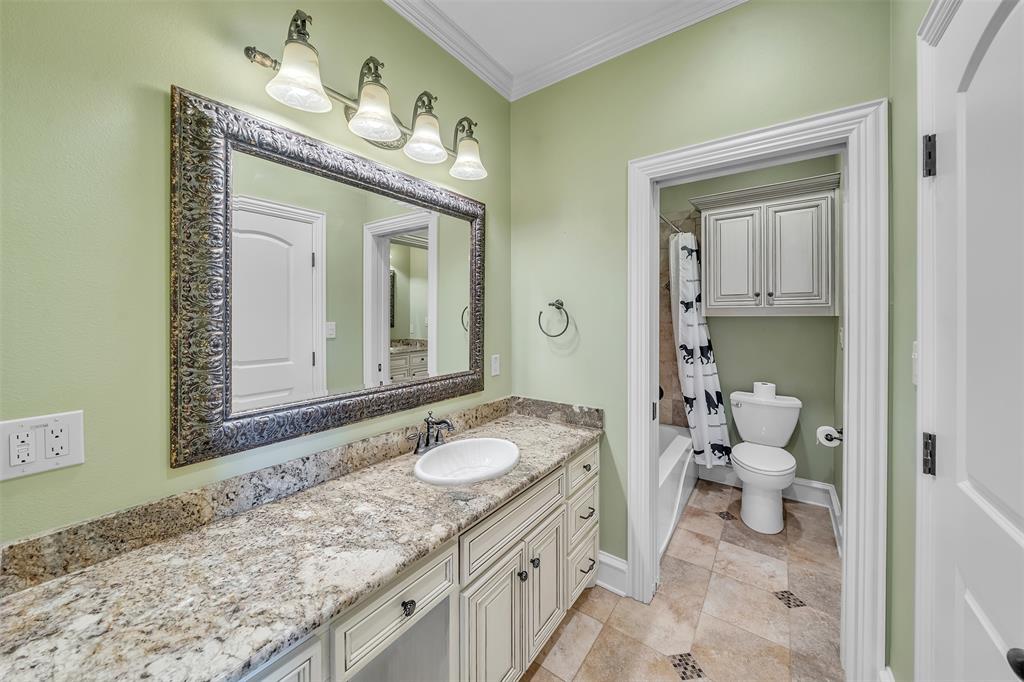 2909 Canyon Creek Drive Sherman, TX 75092 - Photo 28 of 40 a bathroom with a granite countertop sink mirror and a toilet