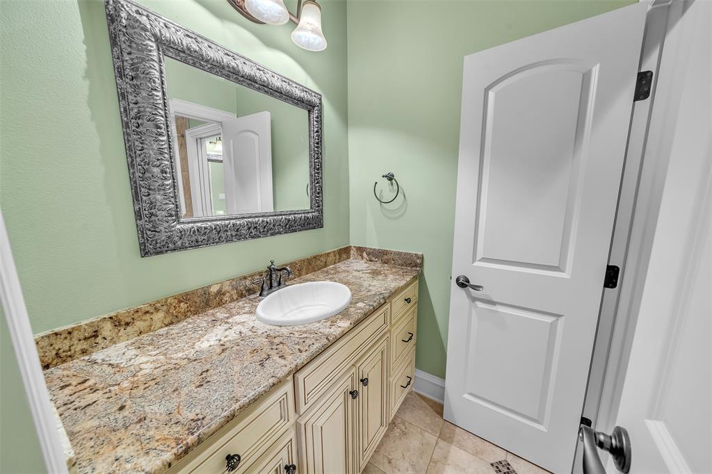 2909 Canyon Creek Drive Sherman, TX 75092 - Photo 32 of 40 a bathroom with a sink and a mirror