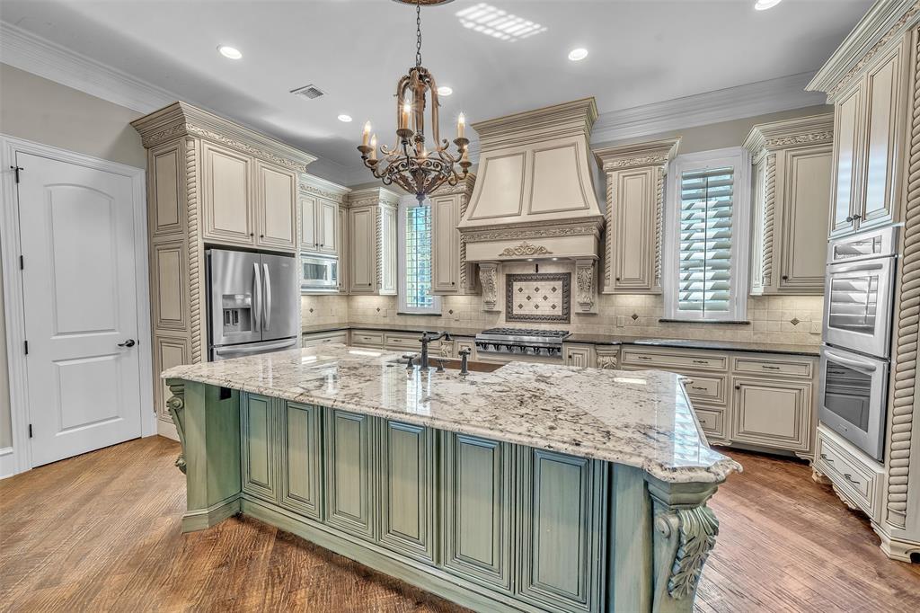 2909 Canyon Creek Drive Sherman, TX 75092 - Photo 9 of 40 a kitchen with stainless steel appliances granite countertop a sink stove and refrigerator