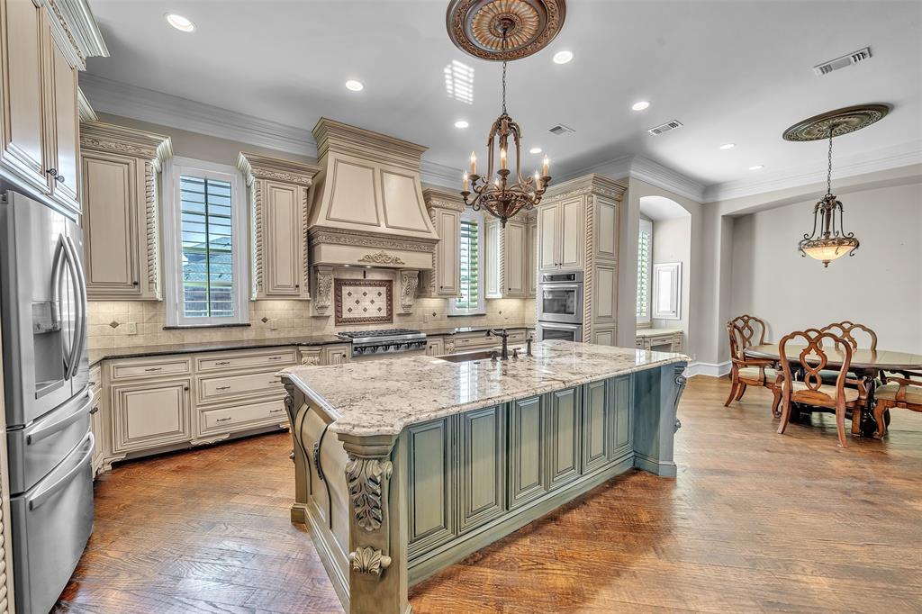 2909 Canyon Creek Drive Sherman, TX 75092 - Photo 10 of 40 a kitchen with stainless steel appliances granite countertop a sink a stove and a wooden floors