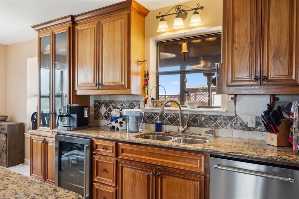 2752 South Branch Road Krum, TX 76249 - Photo 12 of 33 a kitchen with stainless steel appliances granite countertop a sink a stove and a wooden cabinets