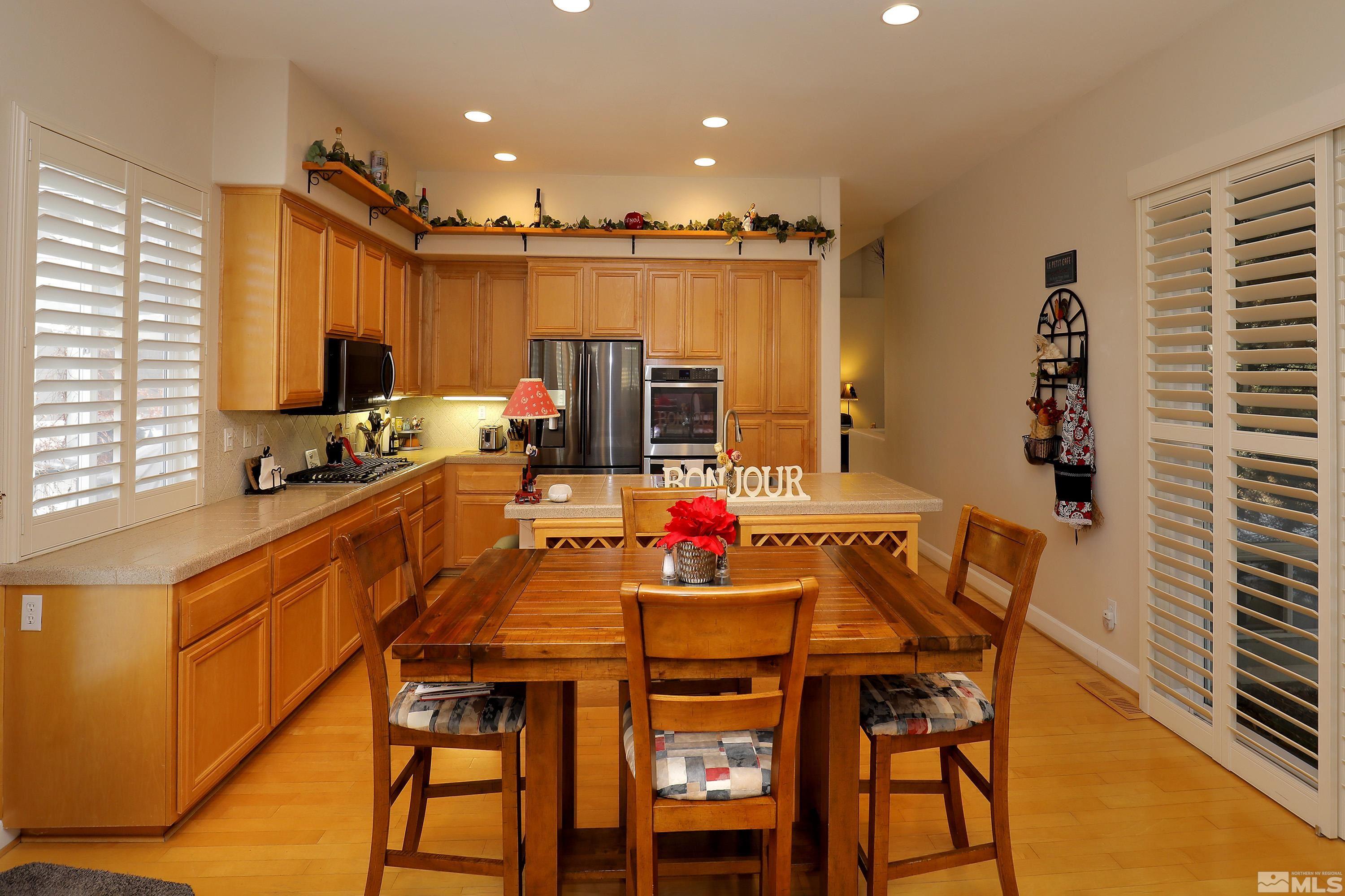 2461 Genoa Genoa, NV 89411 - Photo 15 of 35 a kitchen with stainless steel appliances a dining table chairs and a refrigerator