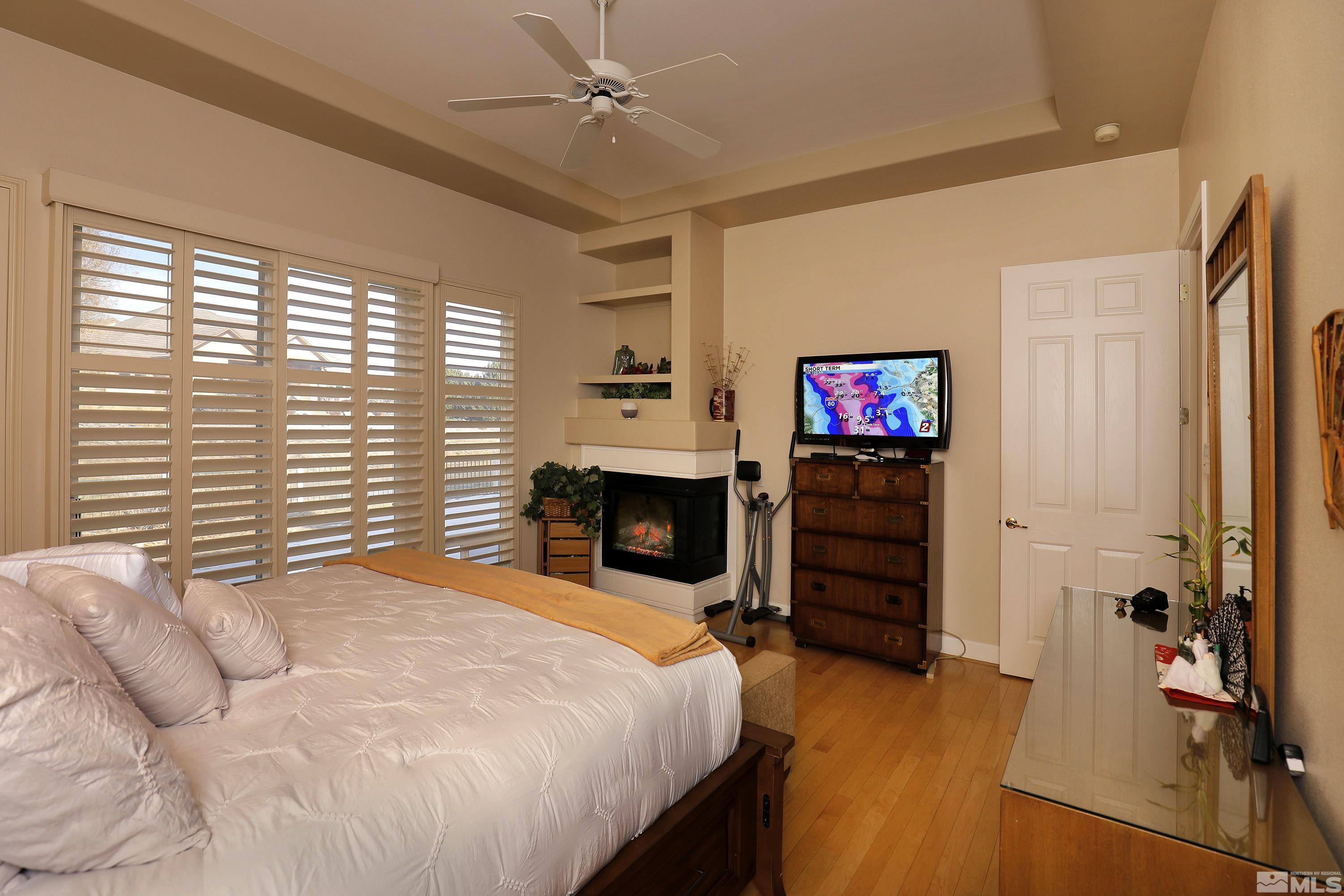 2461 Genoa Genoa, NV 89411 - Photo 19 of 35 a bedroom with a bed and a flat tv screen