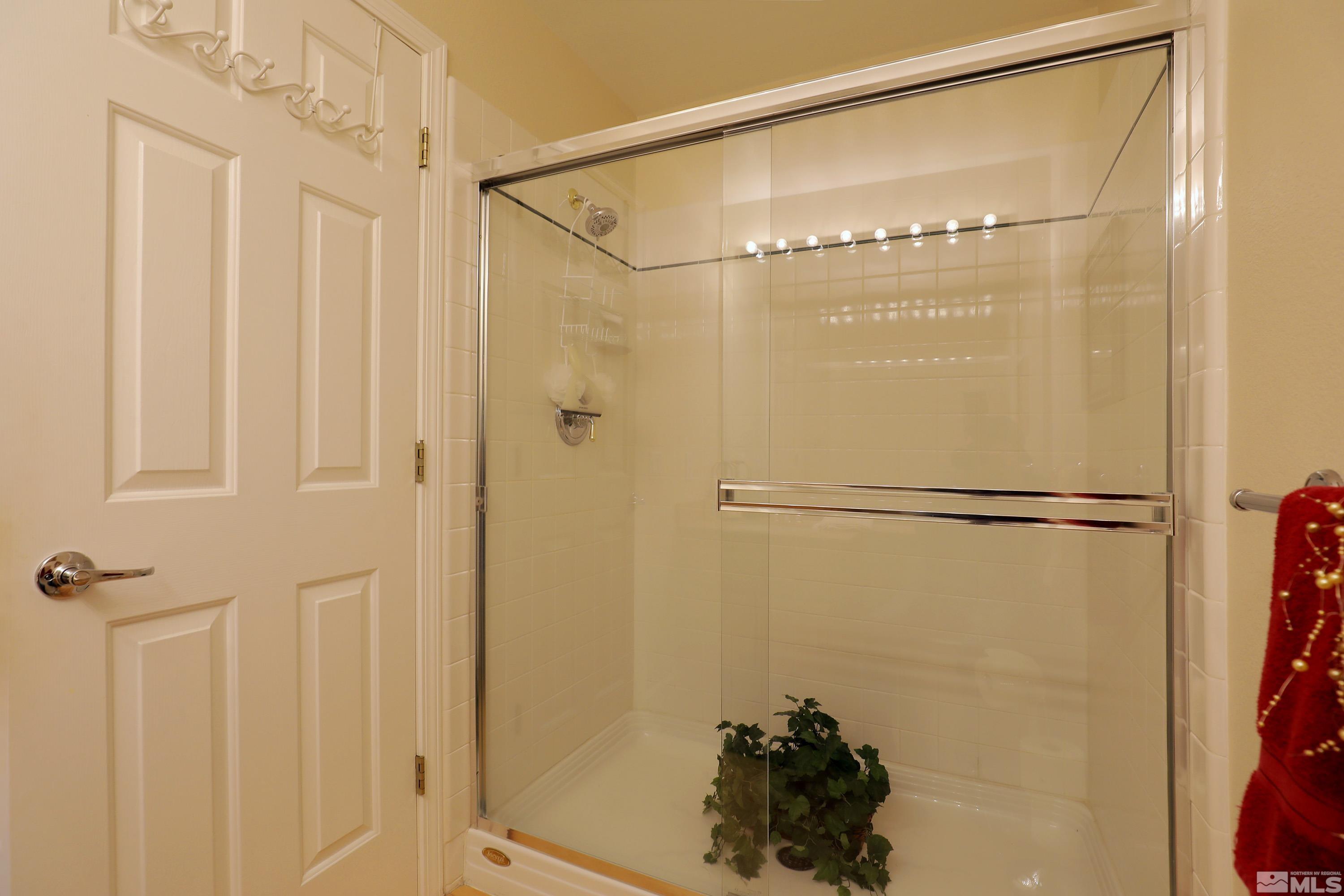 2461 Genoa Genoa, NV 89411 - Photo 26 of 35 a bathroom with a glass shower door