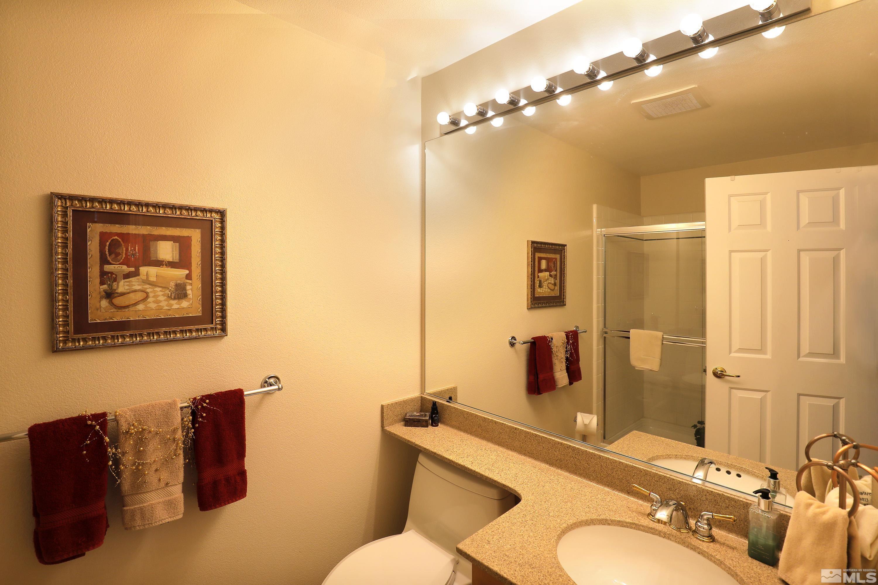 2461 Genoa Genoa, NV 89411 - Photo 28 of 35 a bathroom with a granite countertop sink mirror vanity and toilet