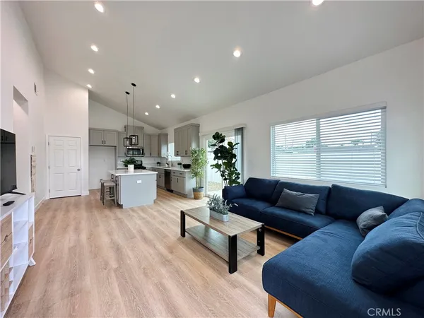 a living room with furniture and kitchen view
