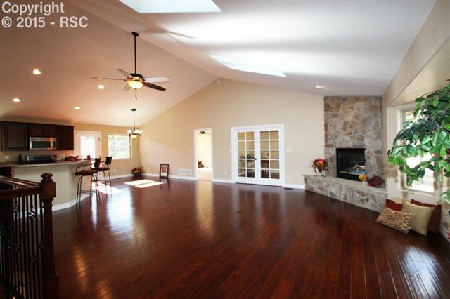 11420 Teachout Road Colorado Springs, CO 80908 - Photo 3 of 36 Living room view from front entry. Four sky lights keep the room well-lighted and the vaulted ceilings are elegant.