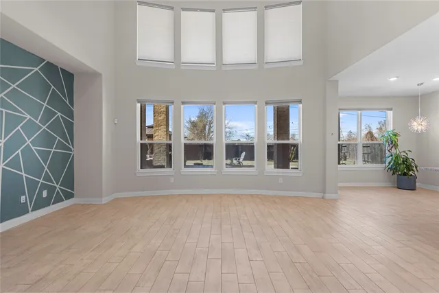 view of empty room with wooden floor and fan