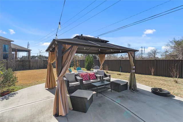 a view of backyard with barbeque grill and outdoor seating