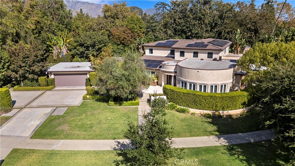 a front view of a house with a yard and fountain