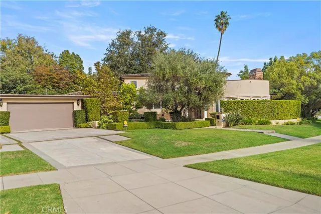 a view of house with swimming pool and sitting area