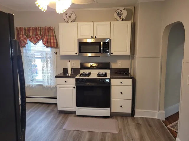 a kitchen with a stove and a refrigerator