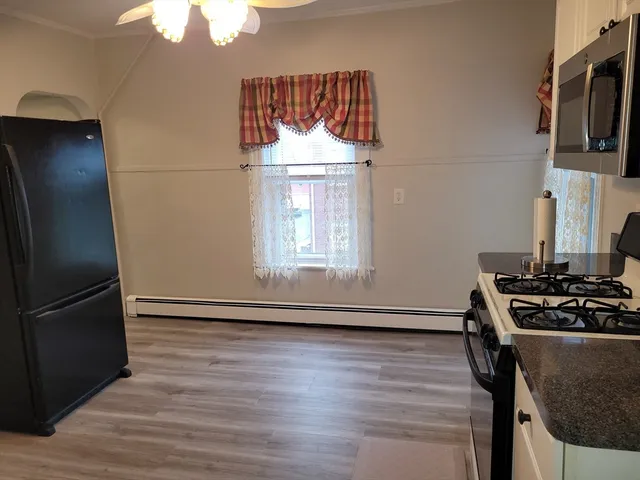 a kitchen with granite countertop a stove and a refrigerator