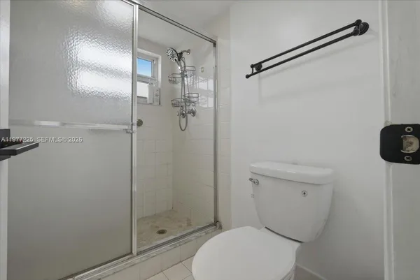 a white toilet sitting next to a bathroom sink