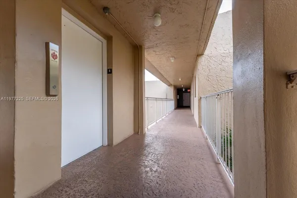 a view of a hallway to rooms