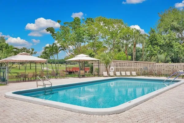 a view of a swimming pool and lounge chairs