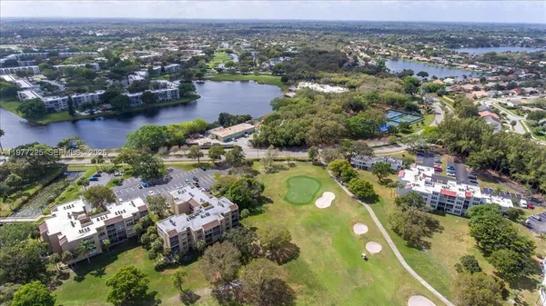 an aerial view of lake residential houses with outdoor space and swimming pool