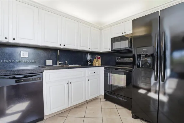 a kitchen with cabinets stainless steel appliances and a counter space