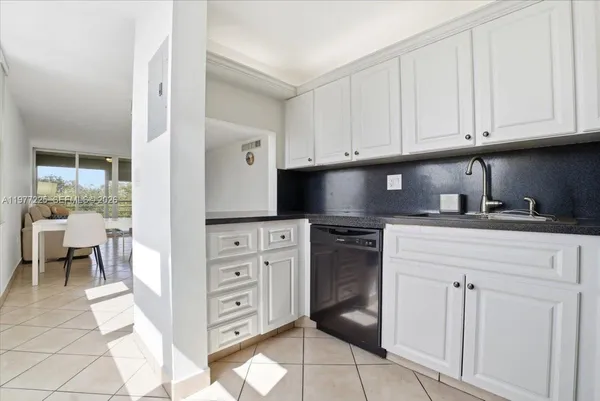 a kitchen with cabinets appliances and a window