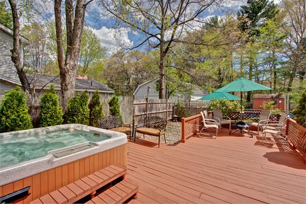 62 Joseph Road Framingham, MA 01701 - Photo 8 of 30 a view of a roof deck with table and chairs under an umbrella with wooden floor
