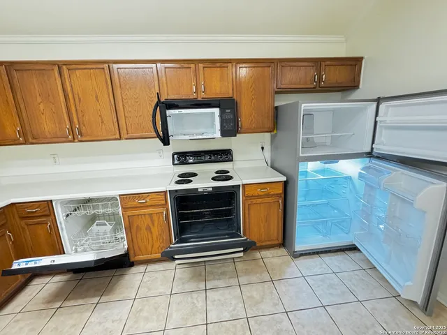 a kitchen with stainless steel appliances granite countertop a stove a microwave and a sink