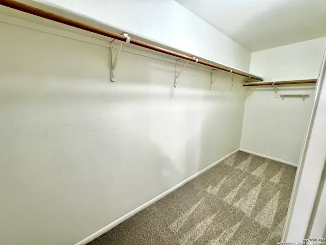 a bathroom with a sink a granite countertop tub and a shower
