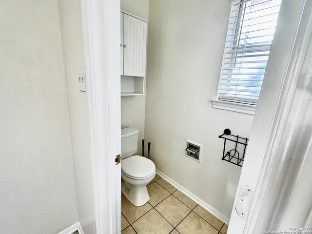 a bathroom with a tub a sink and a window