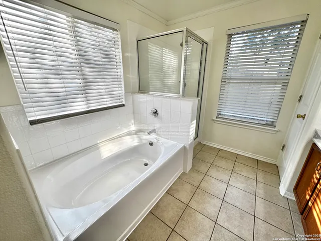 a bathroom with a double vanity sink a mirror and a bathtub