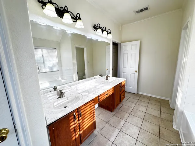 a bedroom with a large bed and a couch