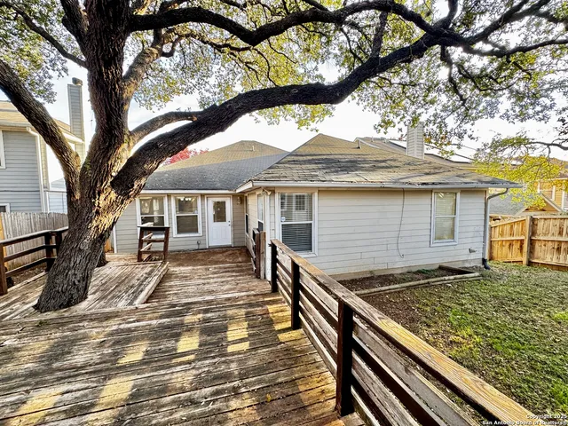 a view of a roof deck with wooden floor and fence
