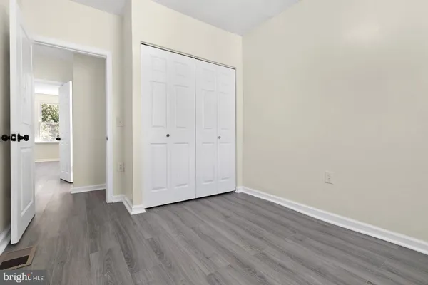 a view of a room with wooden floor