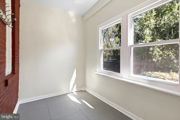 an empty room with wooden floor and a window