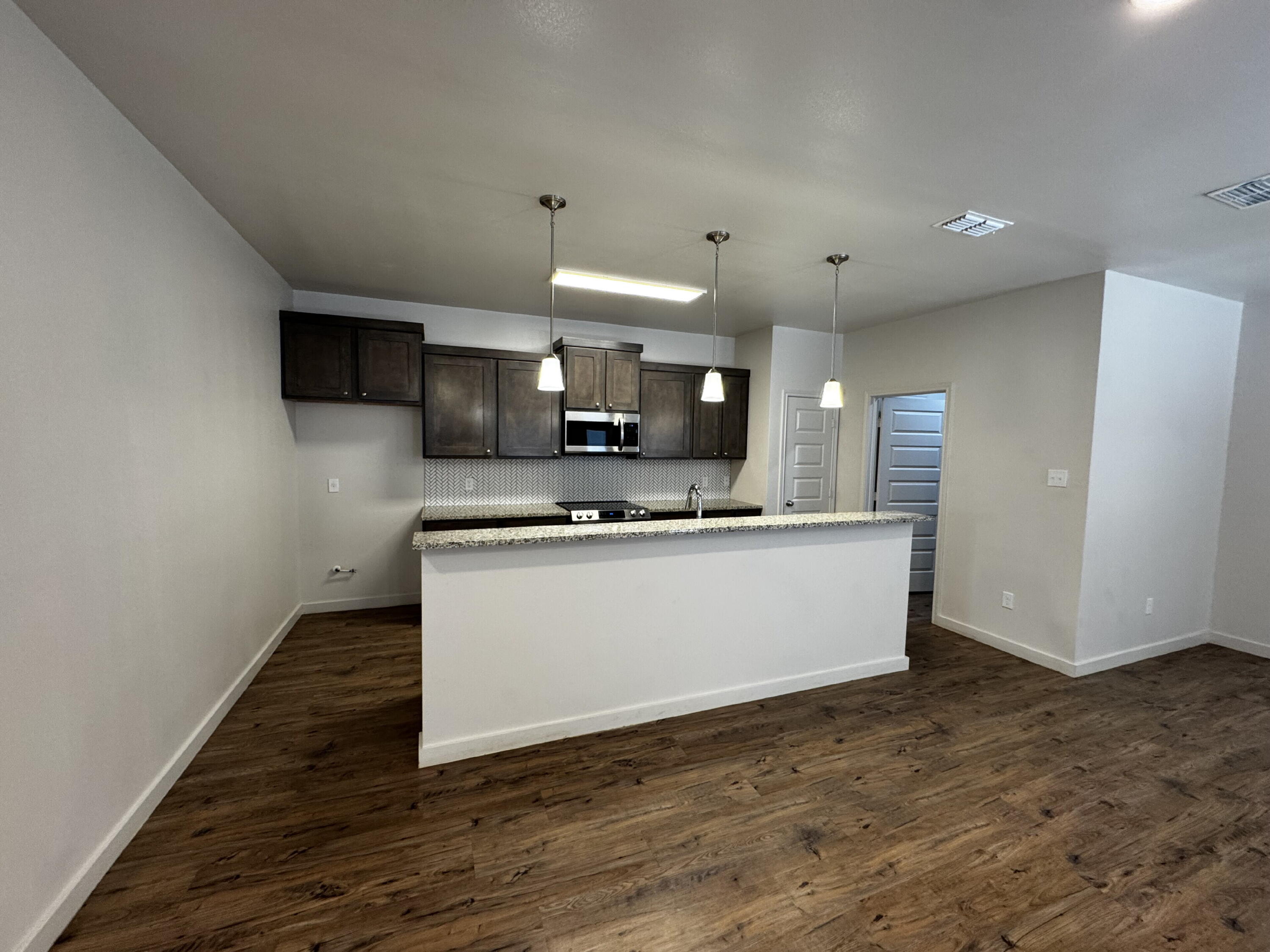 2620 135th Street Lubbock, TX 79423 - Photo 3 of 13 a view of kitchen with stainless steel appliances granite countertop a stove a sink and a microwave