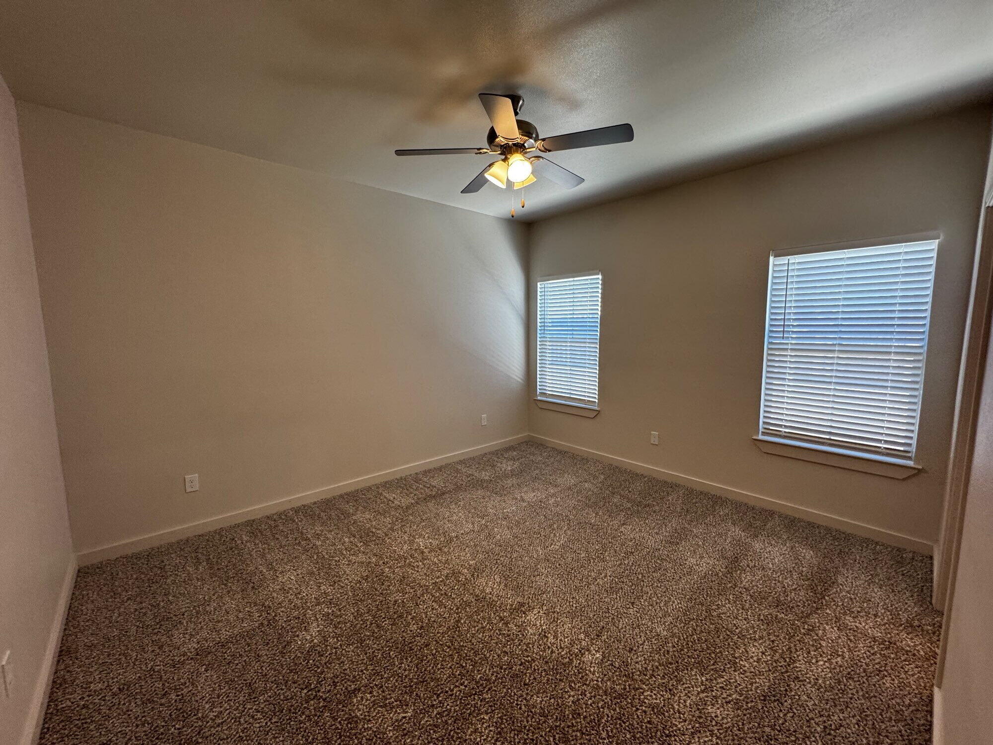 2620 135th Street Lubbock, TX 79423 - Photo 8 of 13 a view of a livingroom with a ceiling fan and window