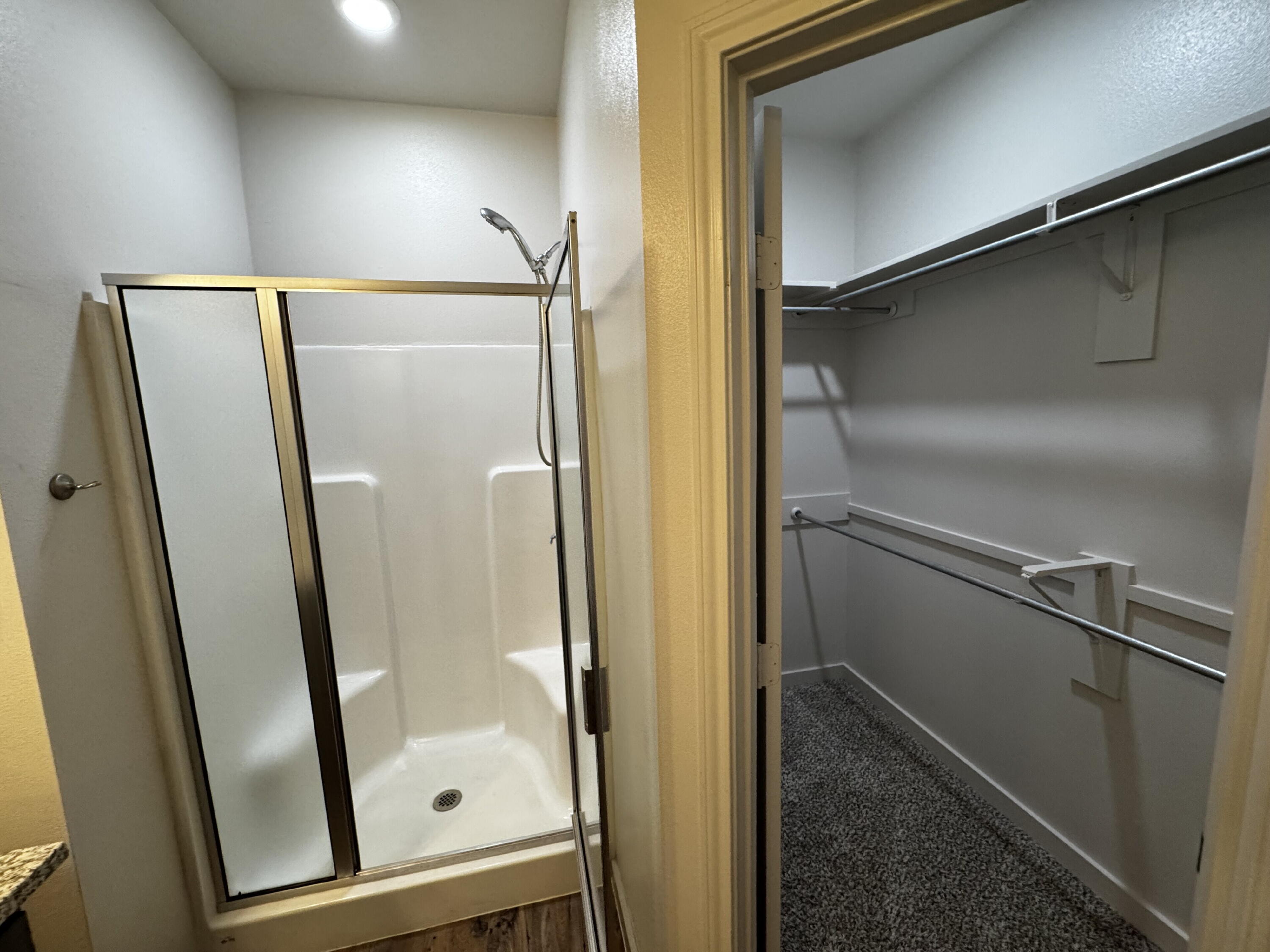 2620 135th Street Lubbock, TX 79423 - Photo 10 of 13 a bathroom with a glass door shower and a mirror