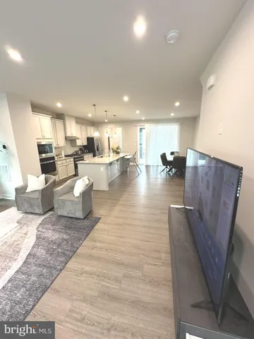 a living room with lots of furniture and kitchen view