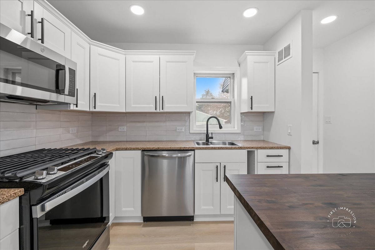506 North Garfield Street Lombard, IL 60148 - Photo 11 of 40 a kitchen with stainless steel appliances a sink stove and cabinets