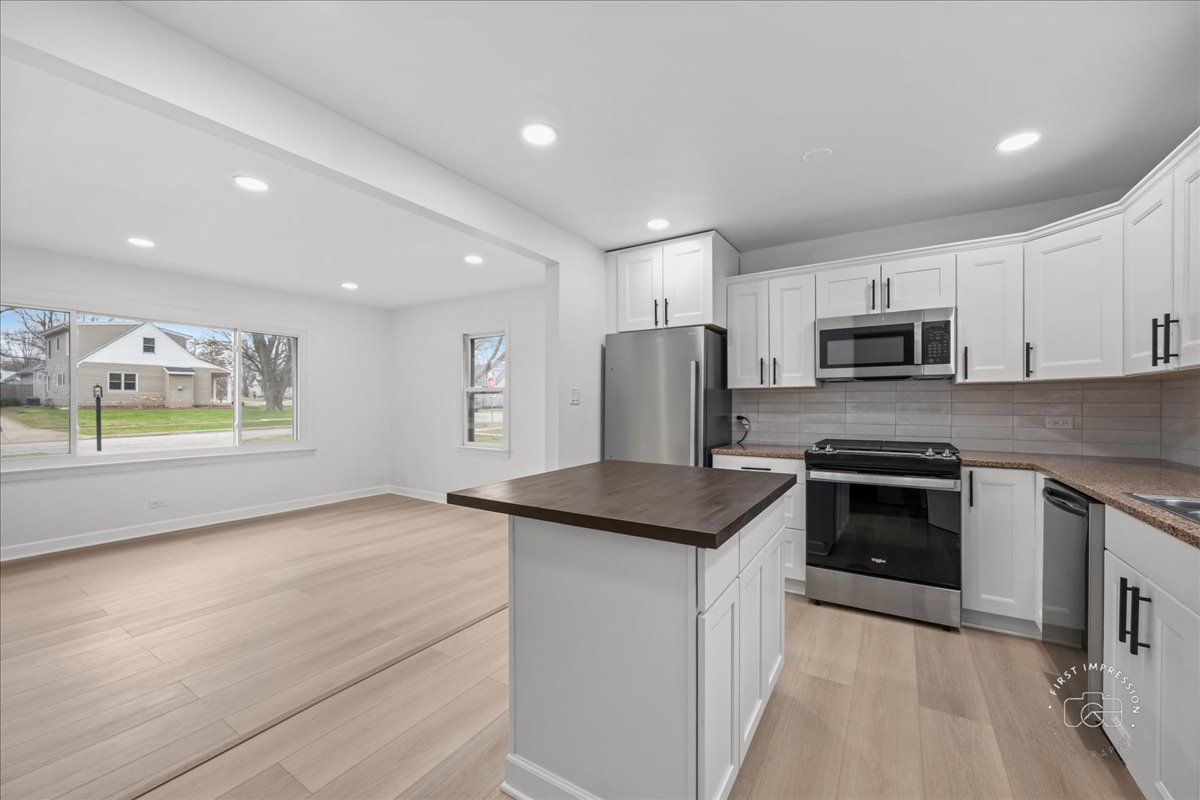 506 North Garfield Street Lombard, IL 60148 - Photo 13 of 40 a kitchen with stainless steel appliances granite countertop a stove a sink and a refrigerator