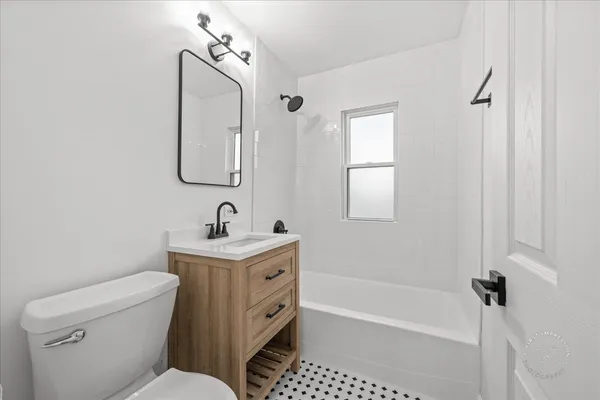 a bathroom with a toilet sink and mirror
